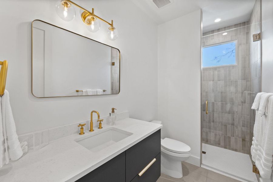 Bathroom with vanity, a stall shower, light tile patterned flooring, and recessed lighting
