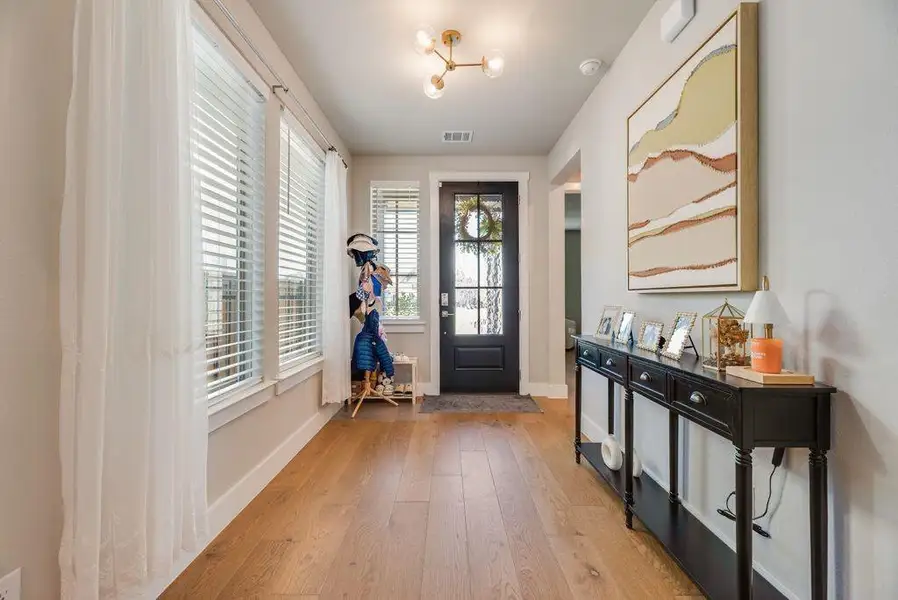 Entrance foyer with light wood-style floors and baseboards