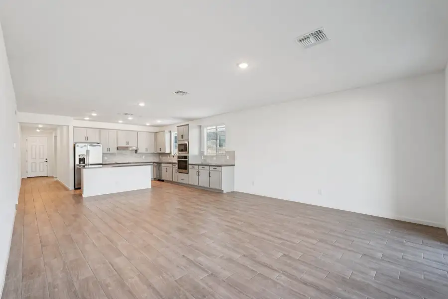 Great room, dining and kitchen. Finishes may vary by community.