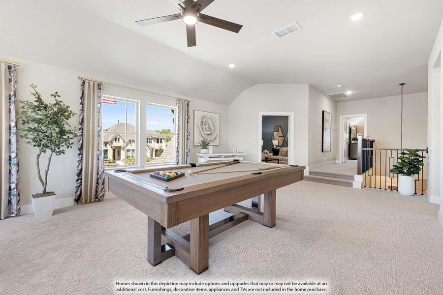 Upstairs game room with pool table, vaulted ceiling, ceiling fan, and carpet flooring near staircase railing