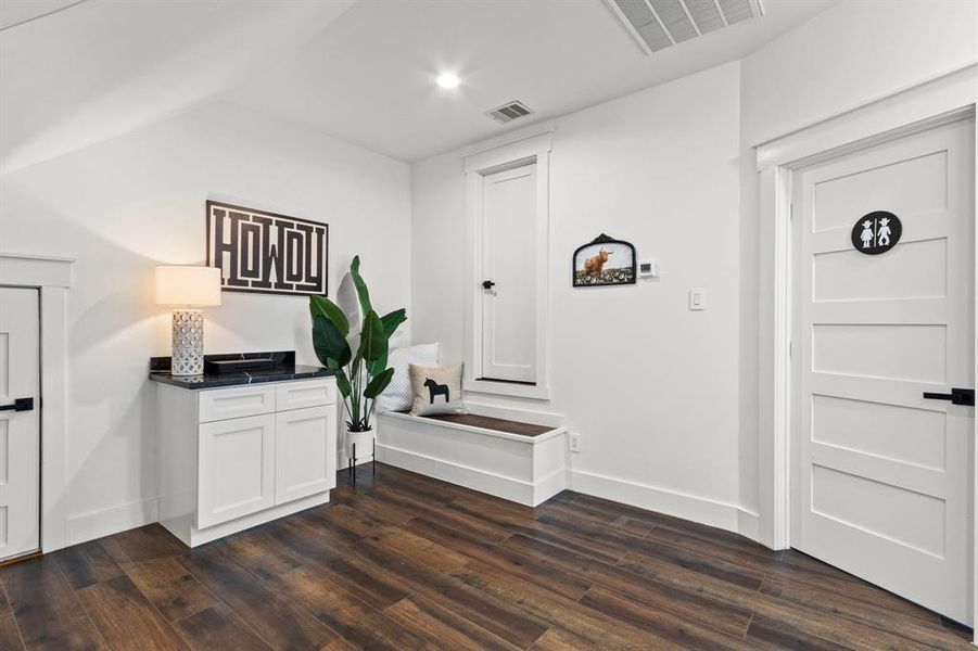 This open landing at the top of the stairs has potential for a kitchen or bar area. Two access doors to the unfinished attic space. Tons of storage are hidden in these doors for the giant Texas attic space.