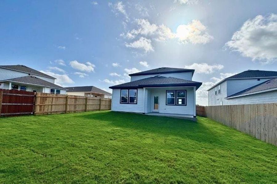 Back of house with a fenced backyard and a patio area Back of house with a fenced backyard and a patio area