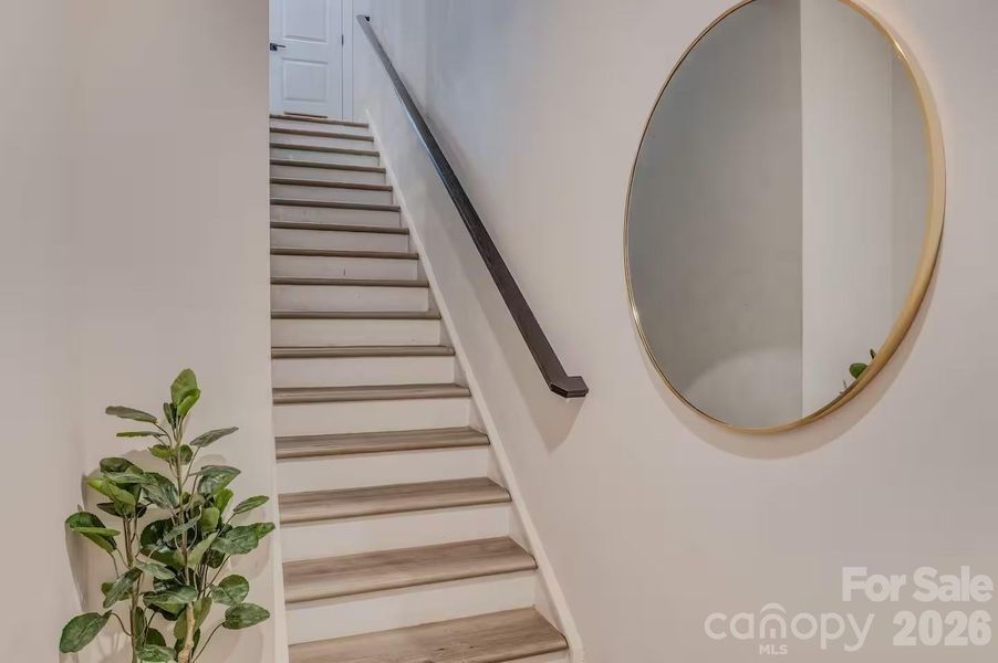 A welcoming entryway with durable luxury flooring and a modern staircase creates a bright, stylish first impression as you enter the home. A welcoming entryway with durable luxury flooring and a modern staircase creates a bright, stylish first impression as you enter the home.