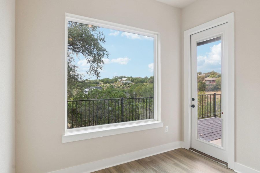 Dining area featuring huge picture window and door leading to deck Dining area featuring huge picture window and door leading to deck