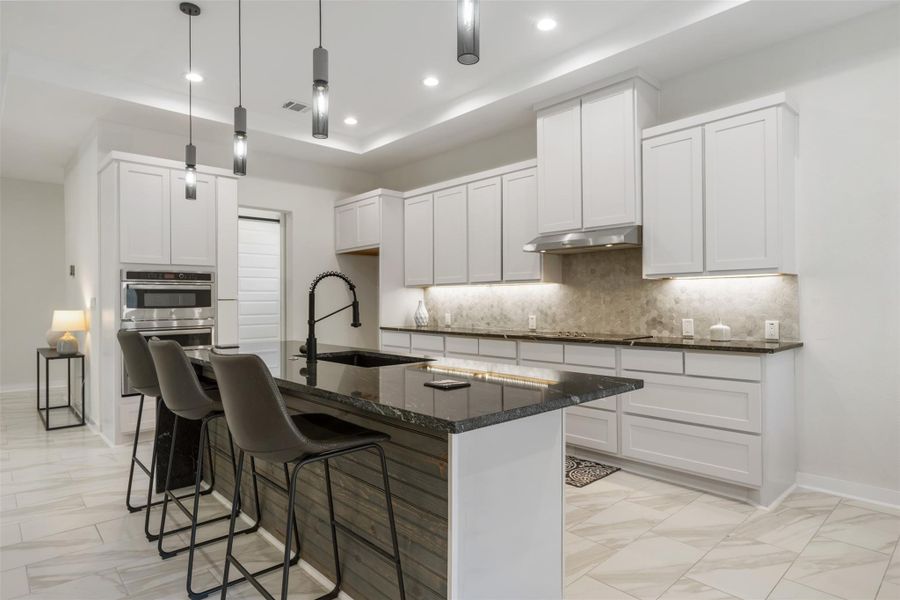 Stainless steel appliances & beautiful tile backsplash.