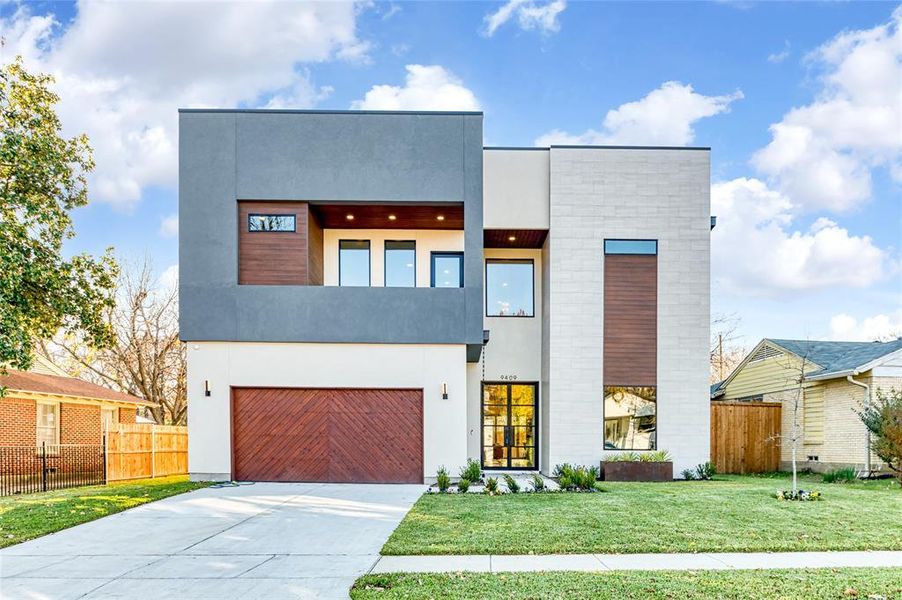 Modern home with a front yard and a garage