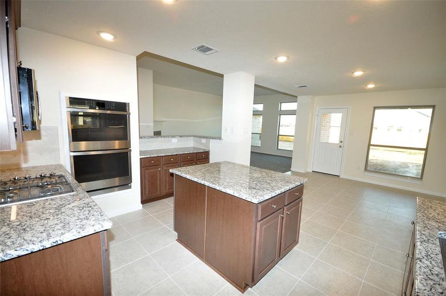 Kitchen os open to the breakfast room and family room