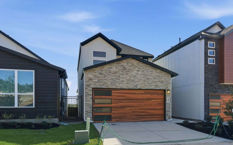 Front exterior of a new home in Centero at Stone Oak, San Antonio, TX, highlighting curb appeal (Image 22).