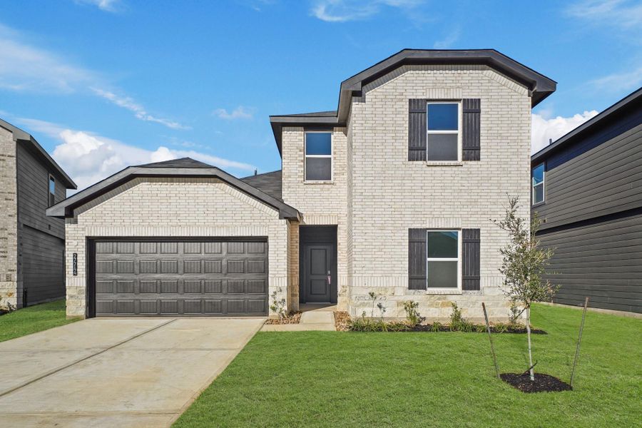 Front exterior of a new home in Grand Pines, Magnolia, TX, highlighting curb appeal (Image 2).