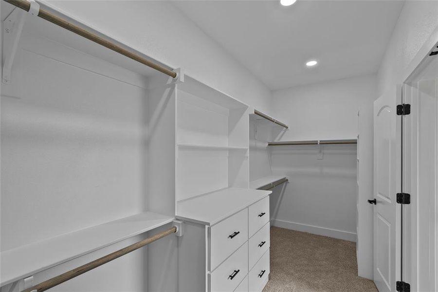 Spacious closet with light colored carpet