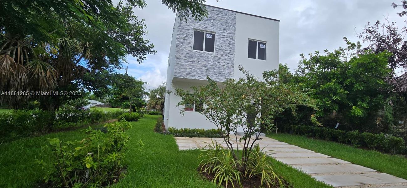 Front exterior of a new home in , Pompano Beach, FL, highlighting curb appeal (Image 1).
