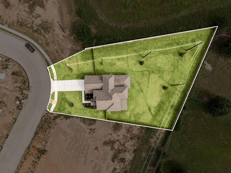 Look at all that outdoor space! This aerial view highlights the home’s large, fully fenced backyard.