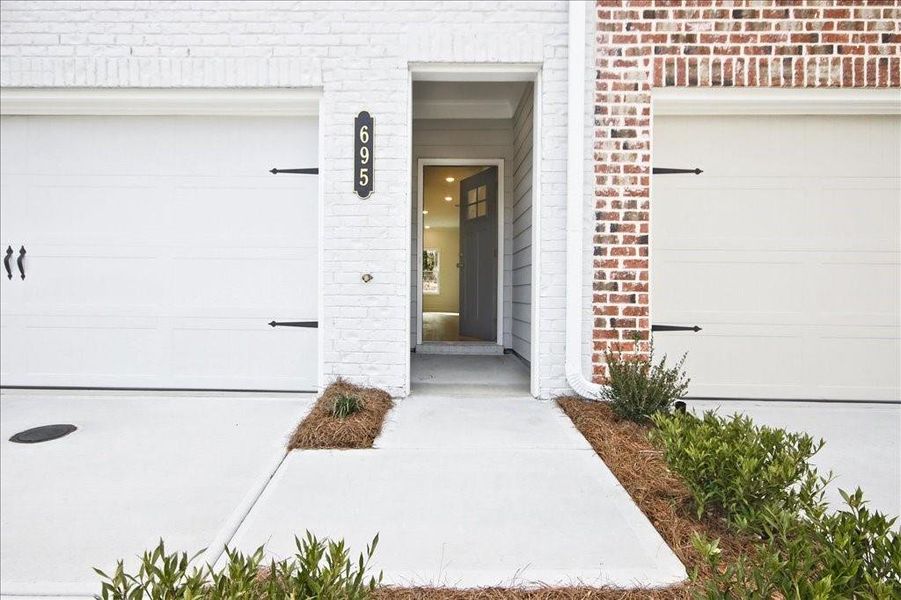 Front exterior of a new home in River Walk Place, Lawrenceville, GA, highlighting curb appeal (Image 20).
