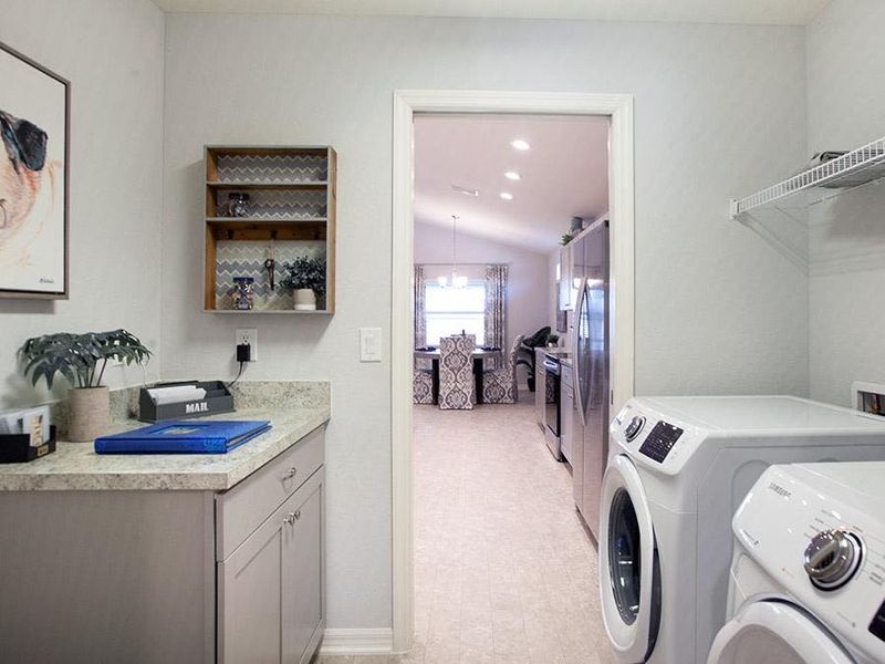 Laundry room with convenient drop zone, to keep life organized - Serendipity home plan by Highland Homes