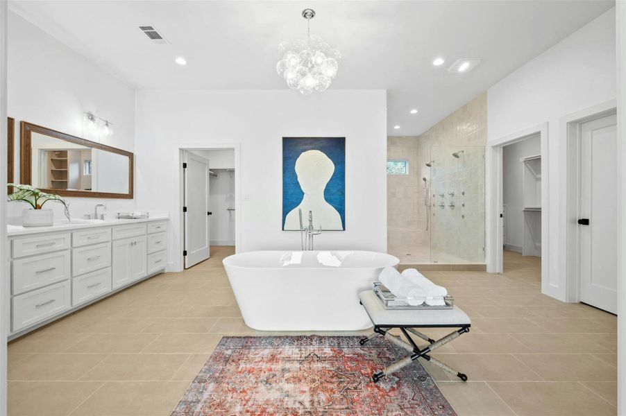 Treat your self to a daily at home ritual with this lavish luxury ensuite bathroom complete with a free-standing soaking tub under a designer chandelier.