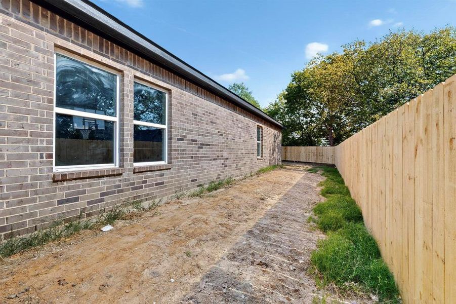 View of side of property featuring brick siding
