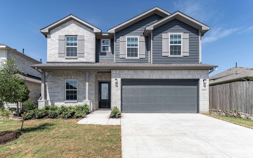 Front exterior of a new home in Travis Ranch, Forney, TX, highlighting curb appeal (Image 1). Front exterior of a new home in Travis Ranch, Forney, TX, highlighting curb appeal (Image 1).