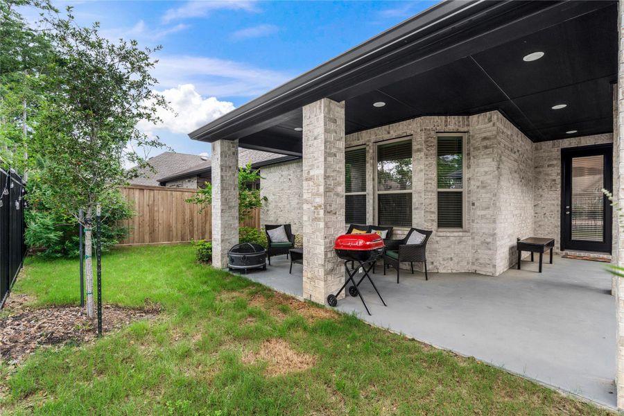 backyard patio with a covered seating area, ideal for outdoor relaxation. backyard patio with a covered seating area, ideal for outdoor relaxation.