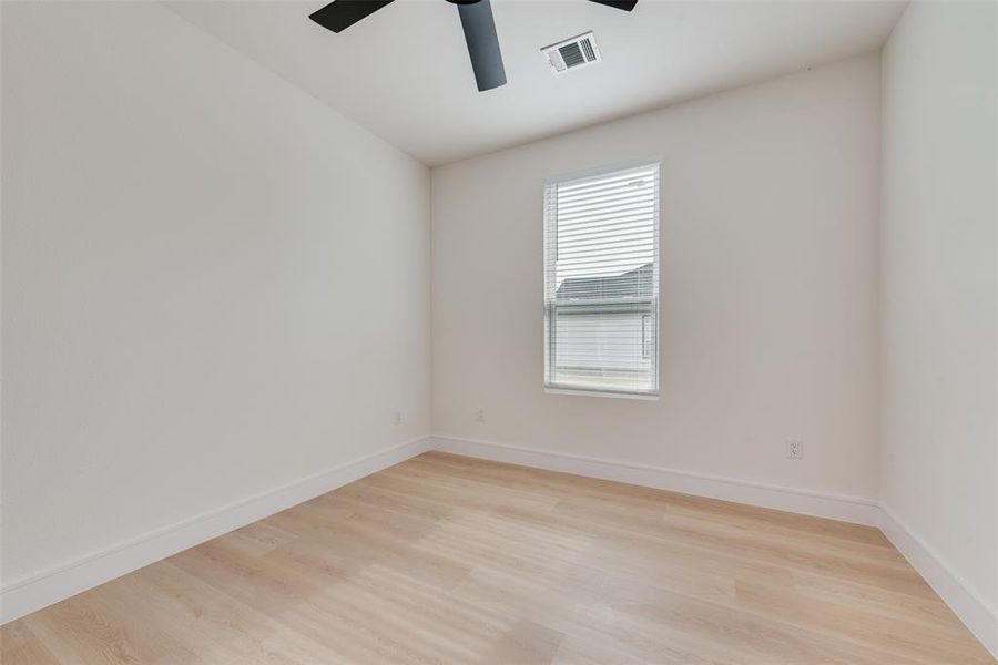 Empty room featuring ceiling fan and light wood-type flooring