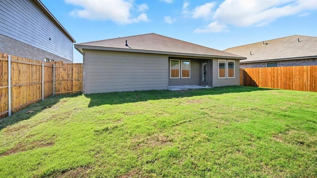 Back of property with a patio area, a shingled roof, and a fenced backyard Back of property with a patio area, a shingled roof, and a fenced backyard