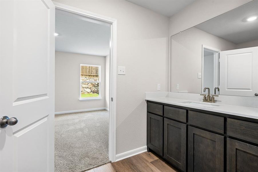 Bathroom featuring vanity and wood finished floors
