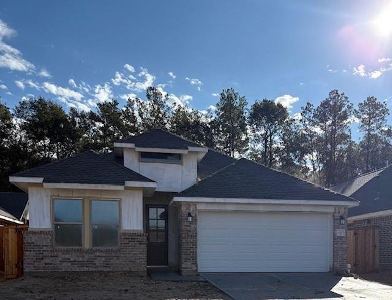 Front exterior of a new home in The Highlands 45', Porter, TX, highlighting curb appeal (Image 1).