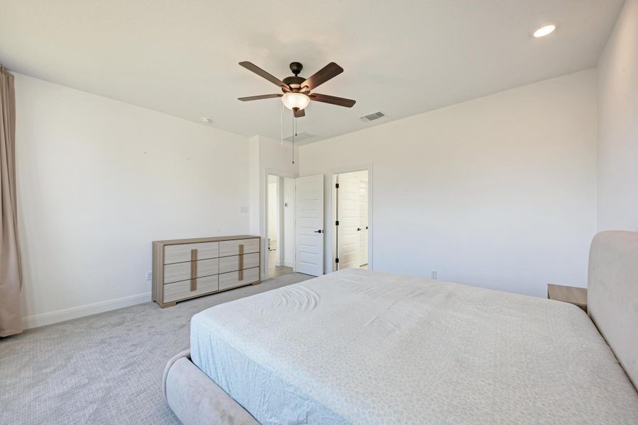 Bedroom with ceiling fan and carpet floors
