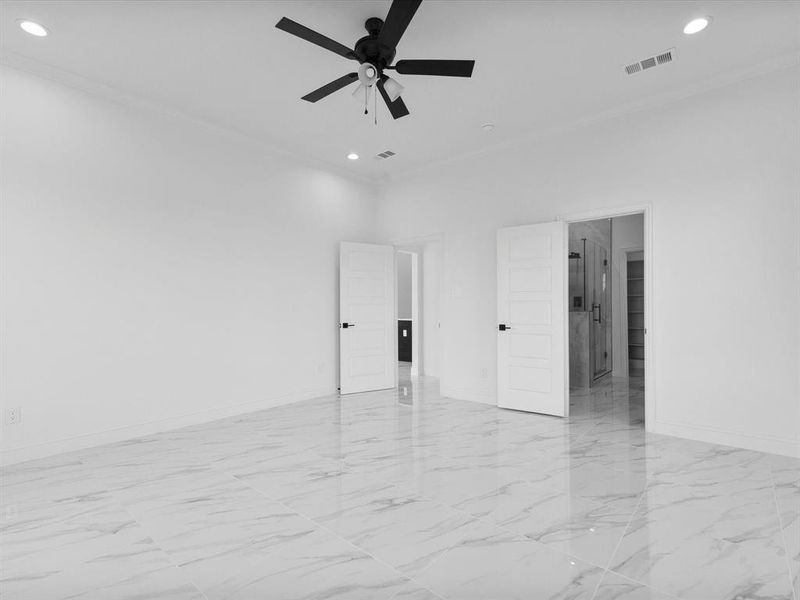 Unfurnished room with crown molding, recessed lighting, baseboards, light marble finish floors, and a ceiling fan