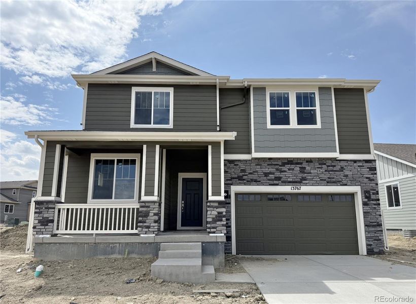 Front exterior of a home in the The Reserve at Looking Glass community, located in Parker, CO (Image 18).