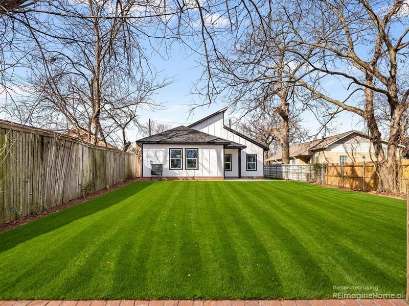 Rear view of house with a fenced backyard, board and batten siding, and a shingled roof Rear view of house with a fenced backyard, board and batten siding, and a shingled roof