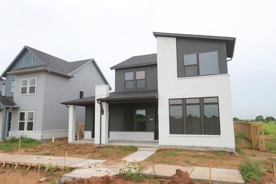 Front exterior of a new home in Indigo 50’ Homesites, Richmond, TX, highlighting curb appeal (Image 1).