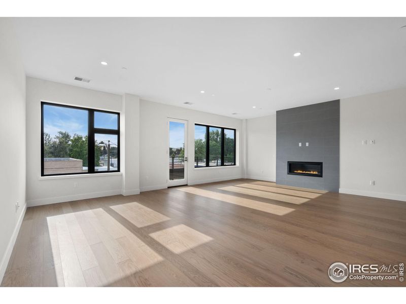 Huge, west facing windows and a glass door leading to patio. The gas fireplace, includes surround tile to the 9 ft, 6 in. ceiling.