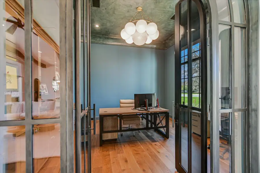 Office space with french doors and light wood-style flooring