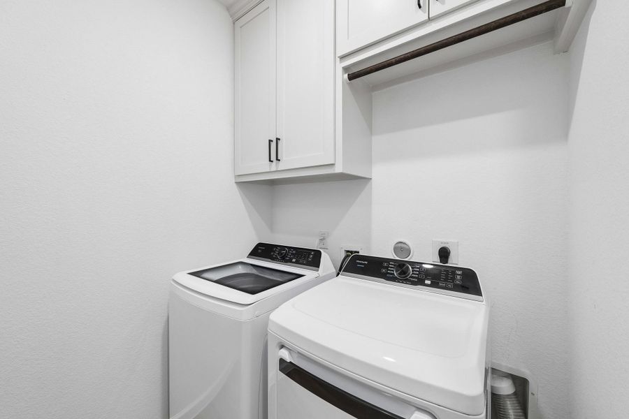 Laundry room had built-in cabinets added along with hanging rod for ease of use on laundry day. Laundry room had built-in cabinets added along with hanging rod for ease of use on laundry day.