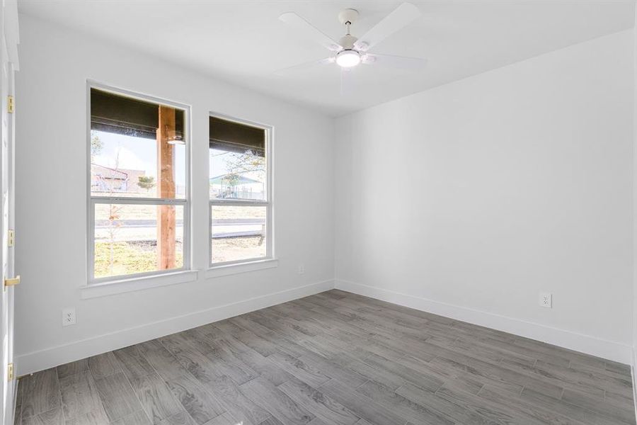 Empty room featuring ceiling fan and wood-type flooring