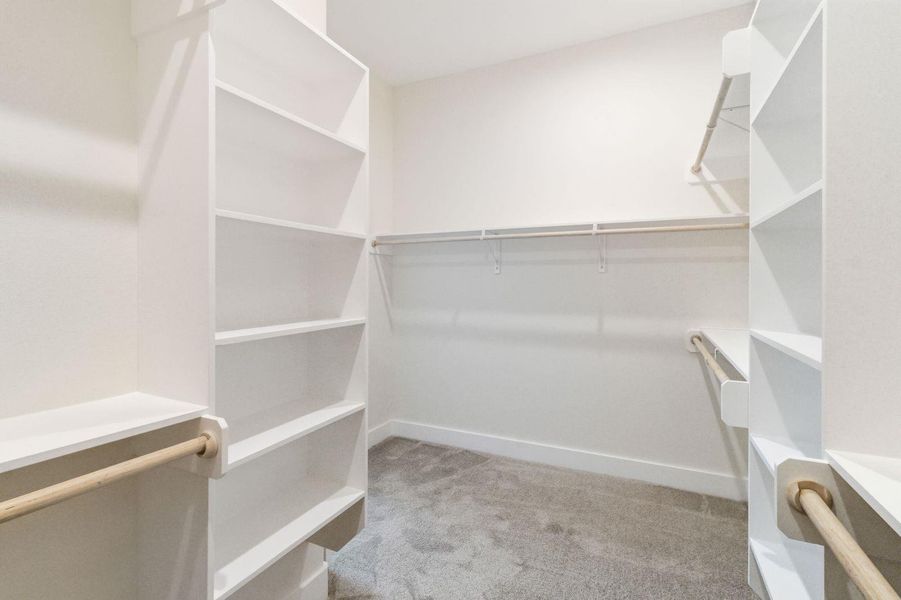 Ample shelving and hanging space defines this well-organized walk-in closet. Ample shelving and hanging space defines this well-organized walk-in closet.