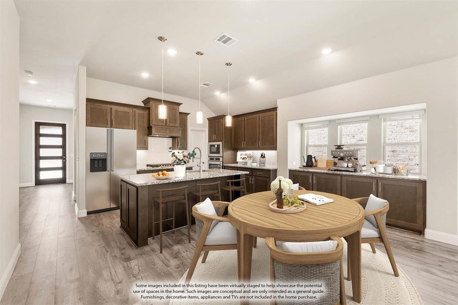 Open kitchen and dining area with dark wood cabinets, granite island, and round wooden dining table on light hardwood floors