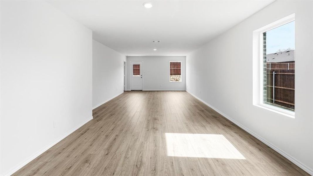 Unfurnished room featuring light wood finished floors, plenty of natural light, and recessed lighting Unfurnished room featuring light wood finished floors, plenty of natural light, and recessed lighting