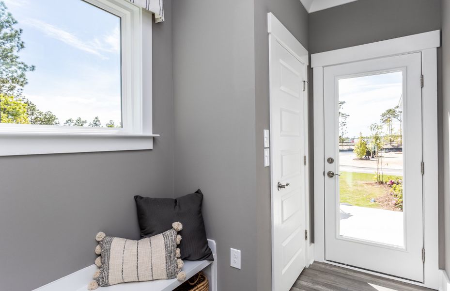 Mud Room leading outside the home. Model Home Representation.