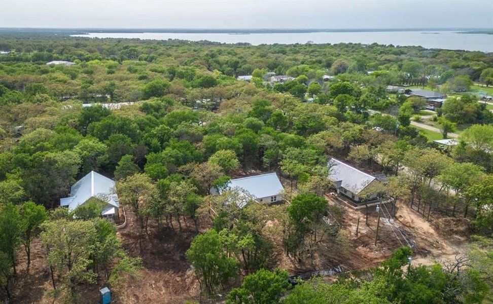 Aerial view of property and surrounding area featuring a large body of water
