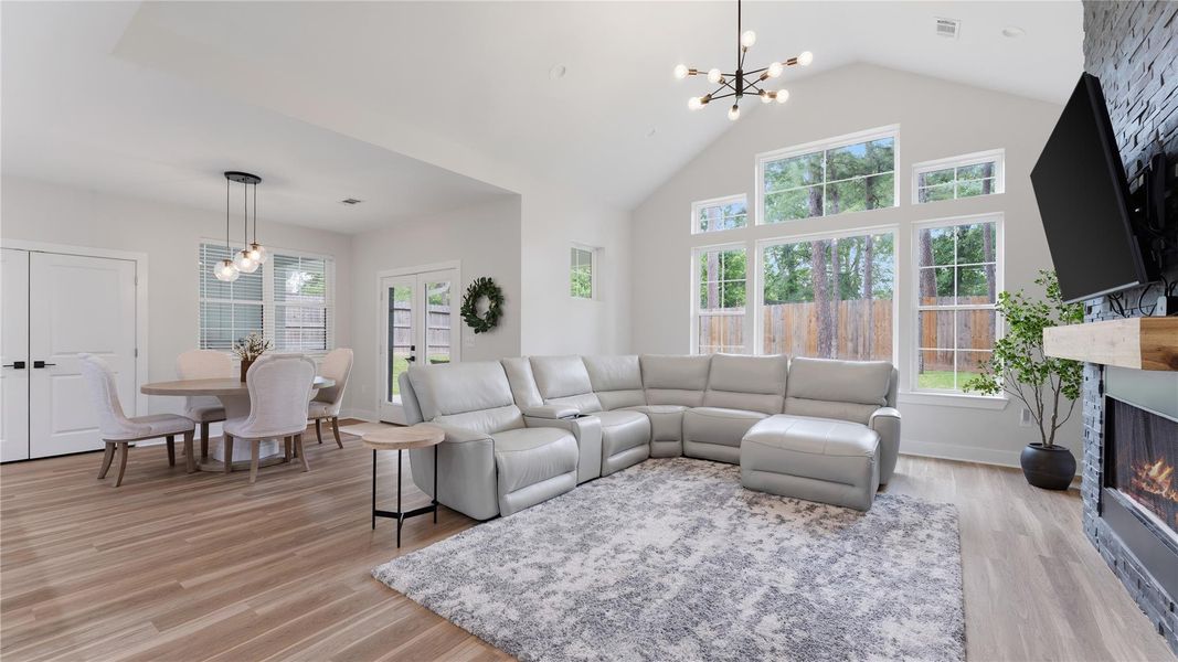 This living room has faulted ceilings, bright lighting and floor to ceiling fireplace. The dining room is off to the left and features nice soft lighting for entertaining.