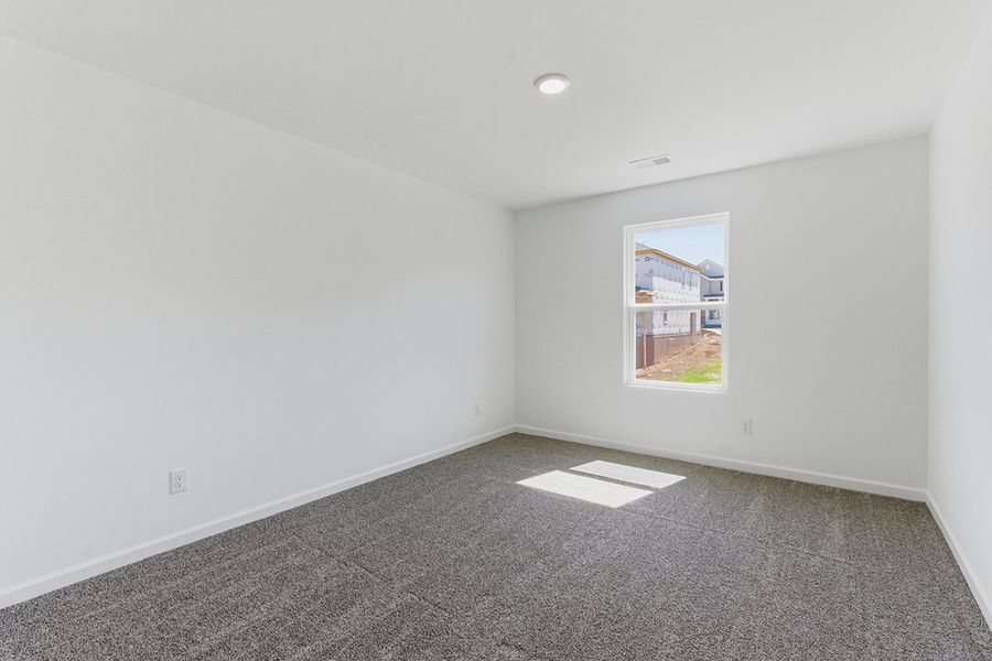 A room with a painting on the wall.