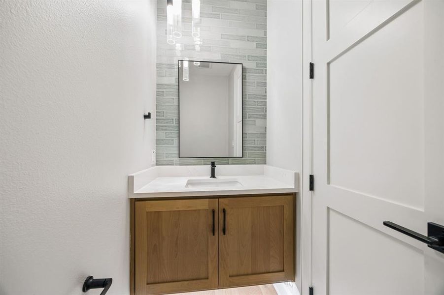 Bathroom with vanity and a textured wall Bathroom with vanity and a textured wall
