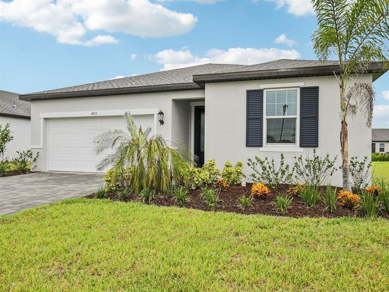 Front exterior of a new home in Magnolia Bay - Reserve Series, Nokomis, FL, highlighting curb appeal (Image 1). Front exterior of a new home in Magnolia Bay - Reserve Series, Nokomis, FL, highlighting curb appeal (Image 1).