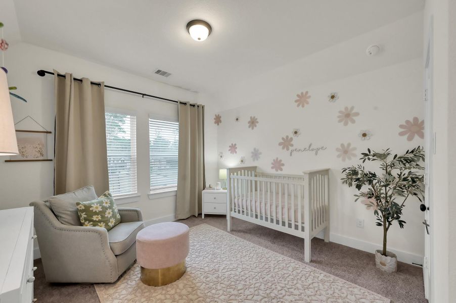 Bright upstairs bedroom filled with natural light and charm.