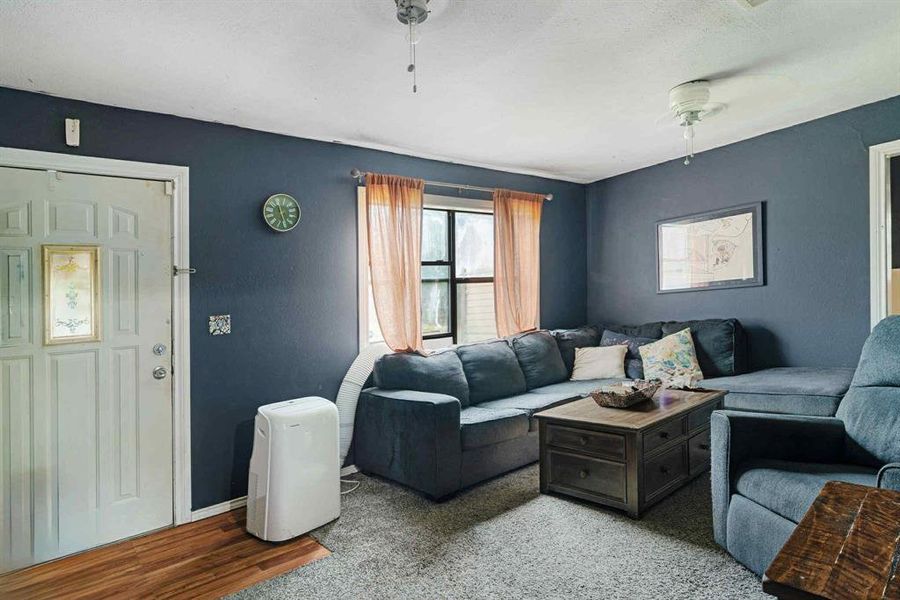 Living room with baseboards and wood finished floors Living room with baseboards and wood finished floors