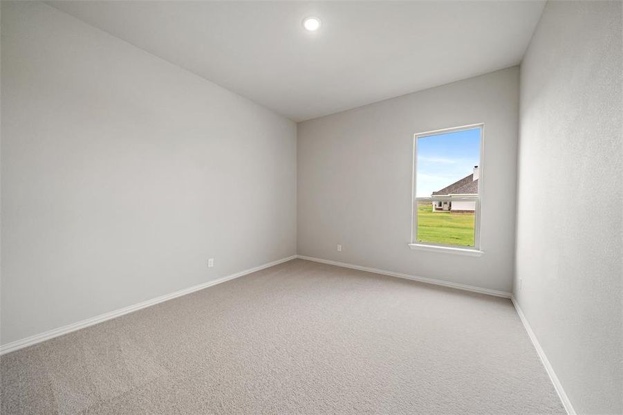 Carpeted empty room featuring baseboards and recessed lighting Carpeted empty room featuring baseboards and recessed lighting