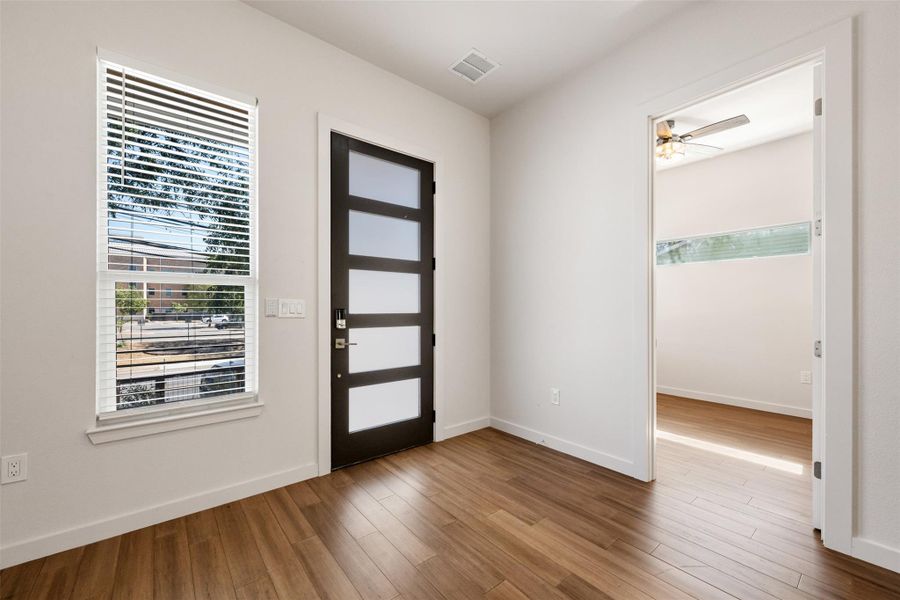 Entryway with wood finished floors, ceiling fan, and healthy amount of natural light