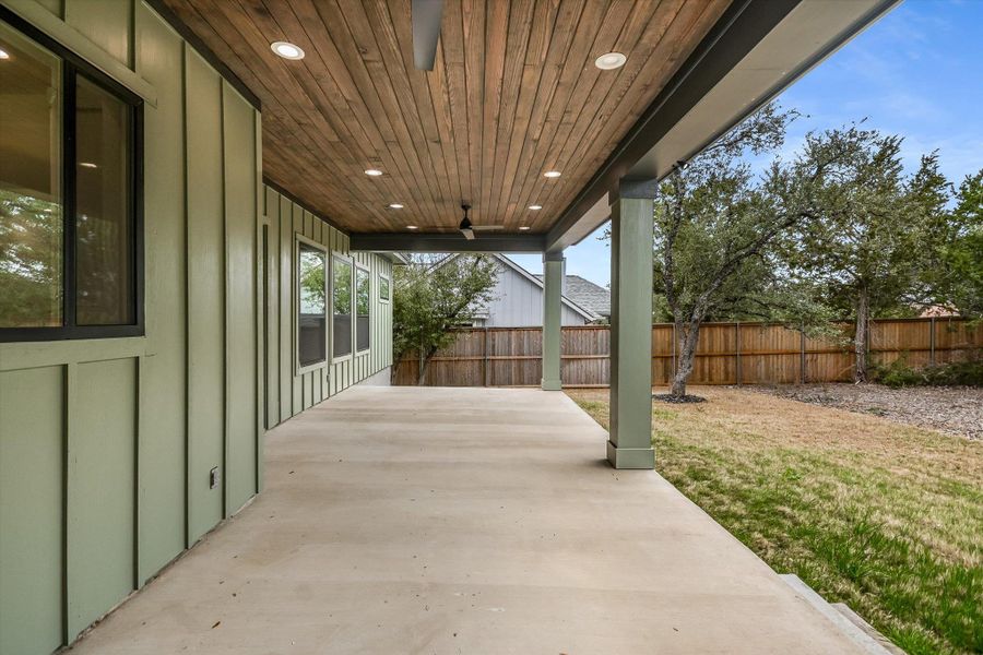 Fenced backyard featuring a patio area and ceiling fan