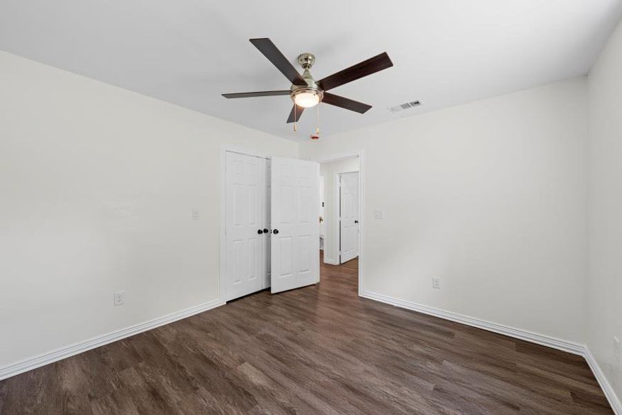 Bedroom featuring wood finished floors and a ceiling fan Bedroom featuring wood finished floors and a ceiling fan